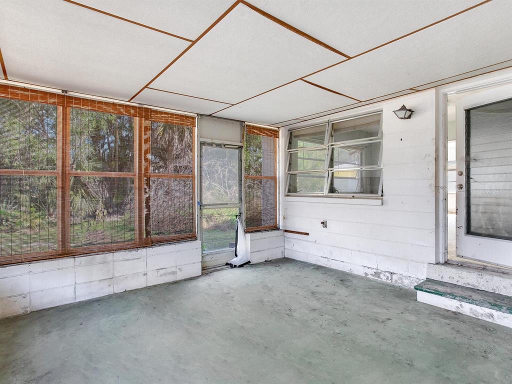 16105 1st Street East Redington Beach, FL 33708 - Photo 26 of 27 a view of an empty room with a fireplace and a large window