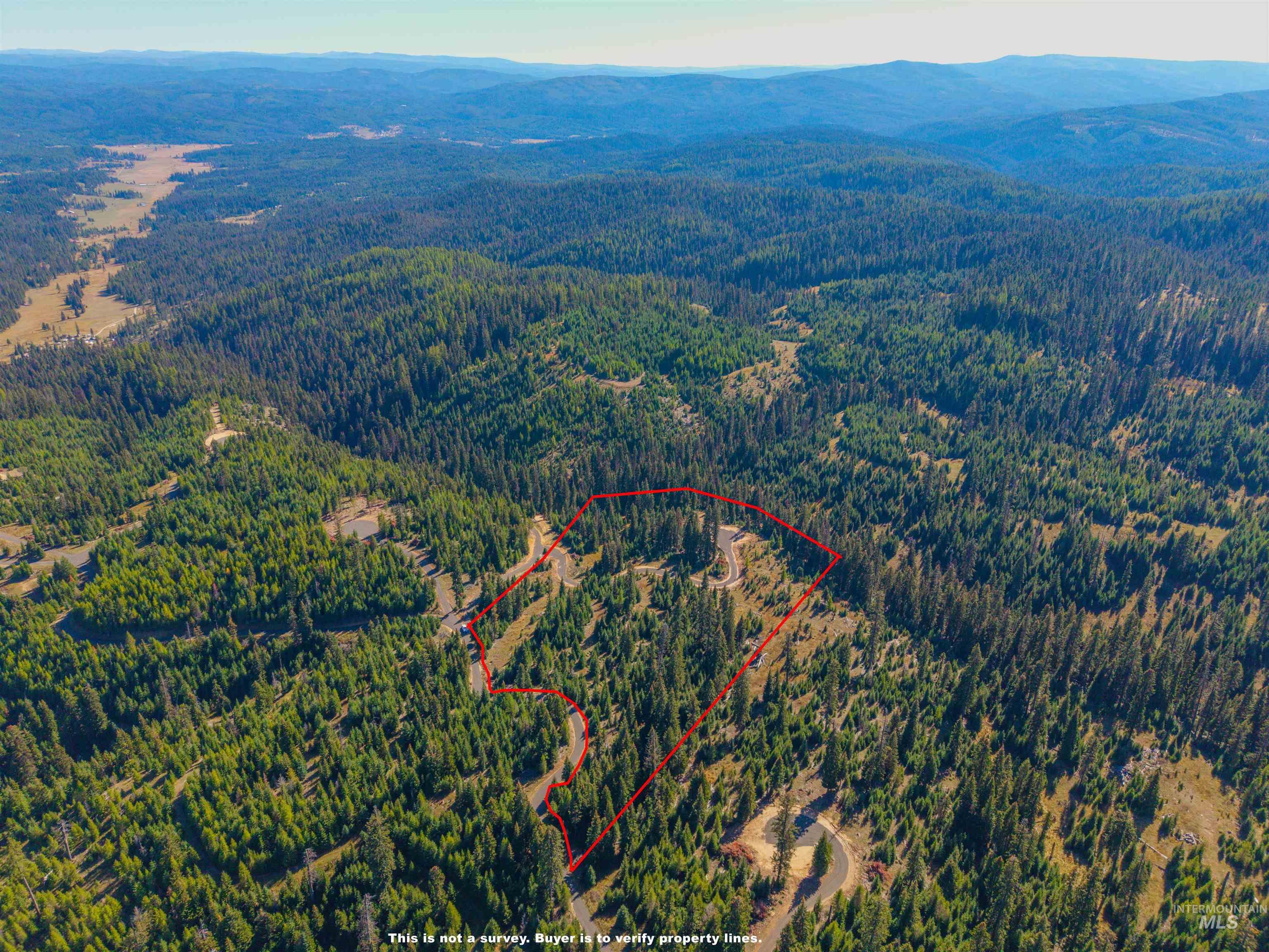 5 Tree Farm Trails Road Elk City, ID 83525 - Photo 2 of 13 Aerial view of property and surrounding area with property boundaries highlighted and a mountain backdrop