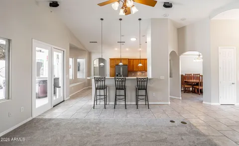 a view of a dining room with furniture and a chandelier