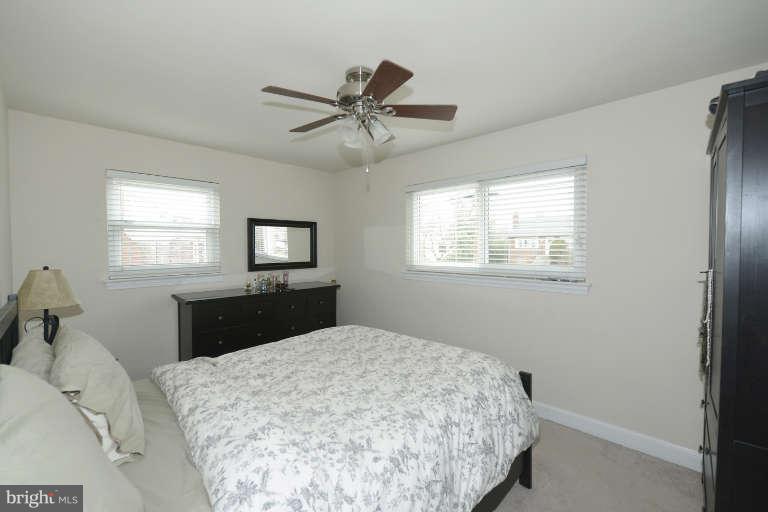 6023 Craig Street Springfield, VA 22150 - Photo 12 of 27 a bedroom with a bed and a dresser