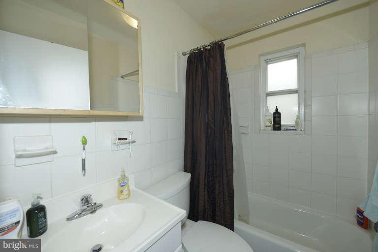 6023 Craig Street Springfield, VA 22150 - Photo 13 of 27 a bathroom with a sink toilet and shower