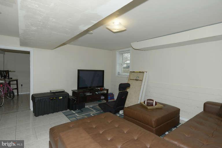 6023 Craig Street Springfield, VA 22150 - Photo 18 of 27 a living room with furniture and a flat screen tv