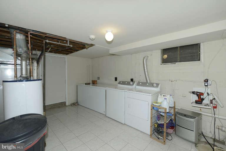 6023 Craig Street Springfield, VA 22150 - Photo 19 of 27 a utility room with cabinets dryer and washer
