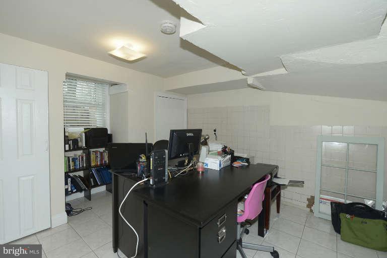 6023 Craig Street Springfield, VA 22150 - Photo 20 of 27 a room with a desk chairs and wooden floor