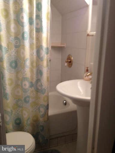 6023 Craig Street Springfield, VA 22150 - Photo 21 of 27 a bathroom with a sink toilet and shower