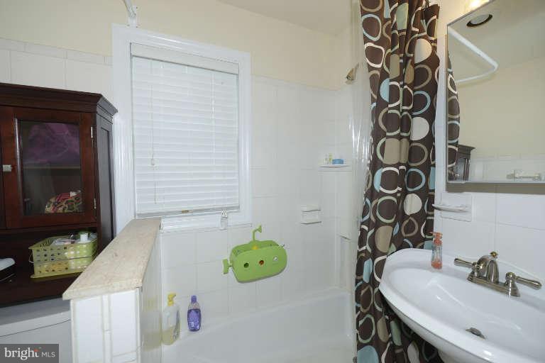 6023 Craig Street Springfield, VA 22150 - Photo 6 of 27 a bathroom with a sink and a mirror