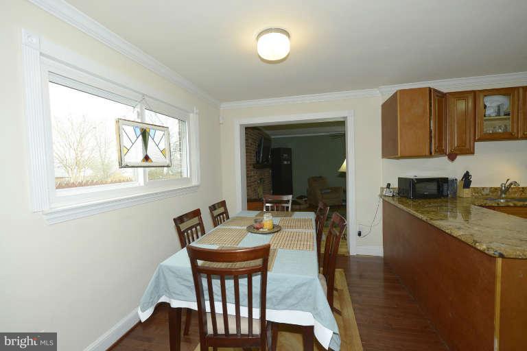 6023 Craig Street Springfield, VA 22150 - Photo 8 of 27 a view of a dining room with furniture and wooden floor
