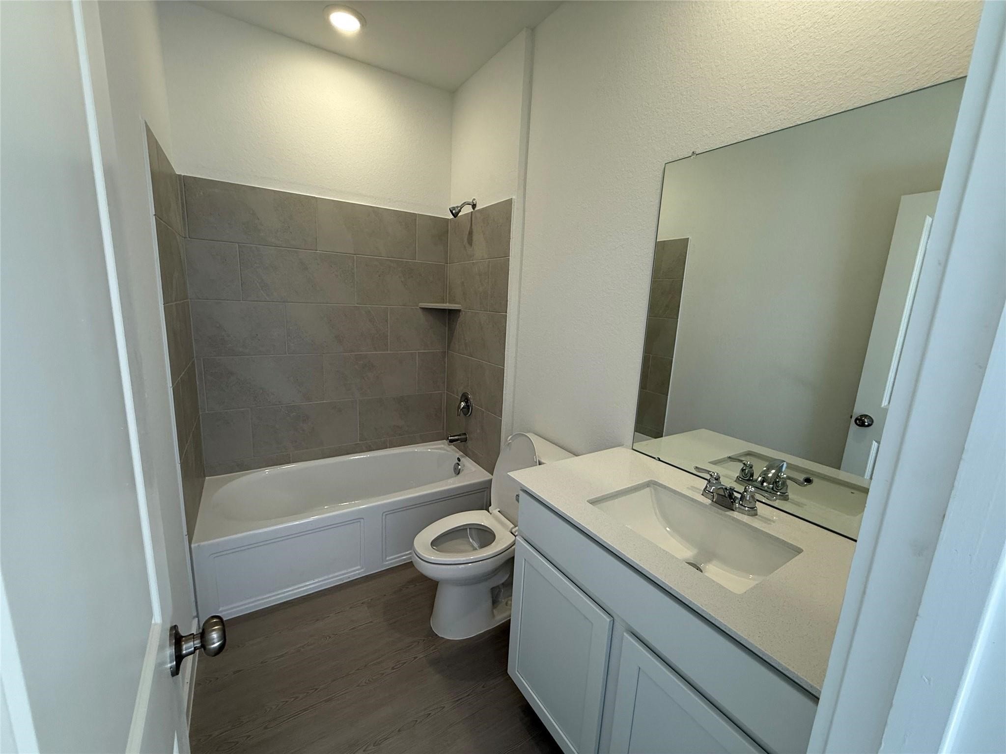 10611 Summers Way Beasley, TX 77417 - Photo 20 of 35 a bathroom with a granite countertop sink toilet and shower