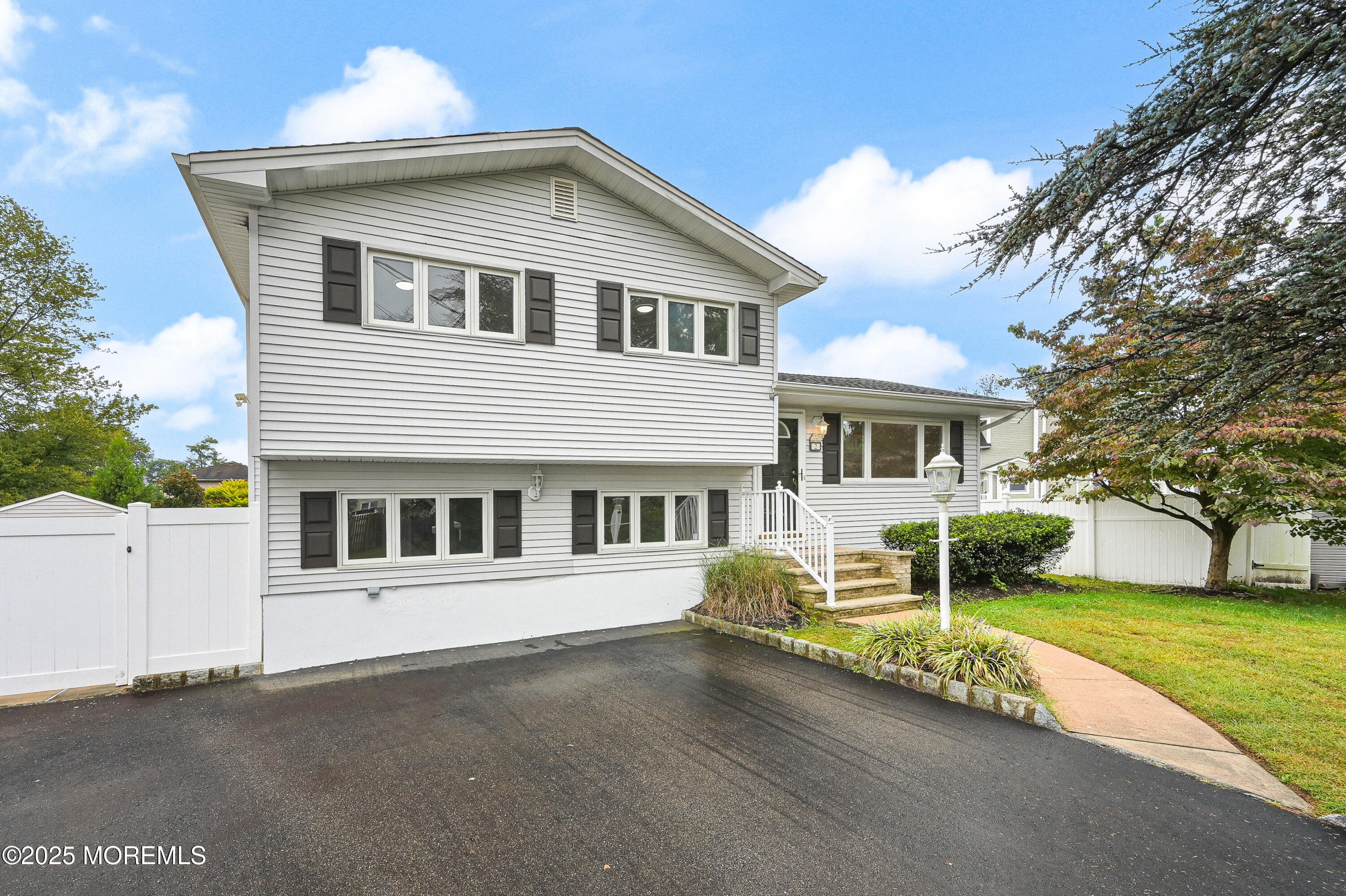a front view of a house with a garden and plants