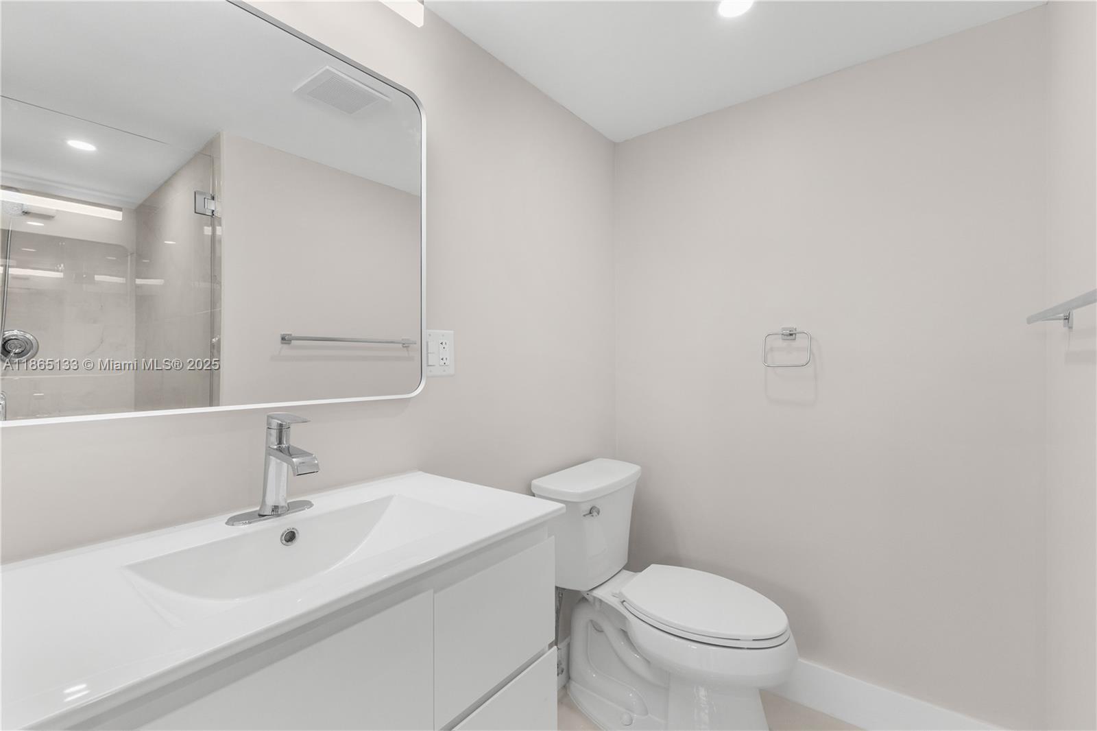 1331 Lincoln Road, Unit 1302 Miami Beach, FL 33139 - Photo 20 of 40 a white toilet sitting next to a bathroom sink