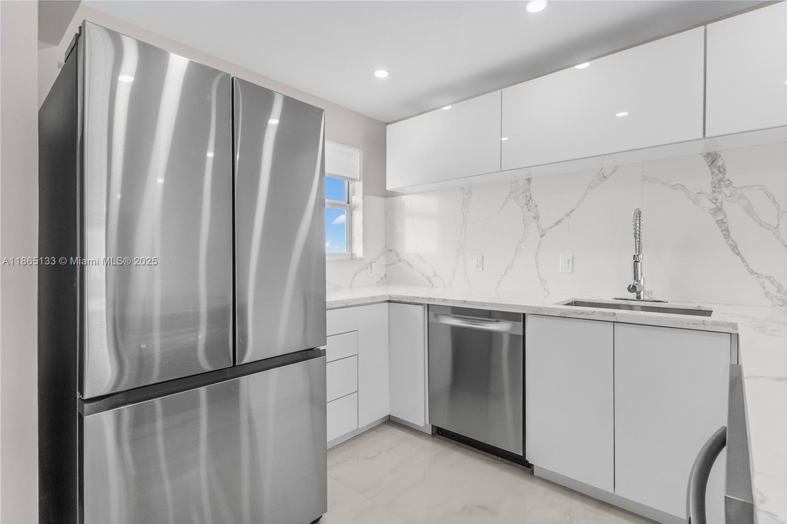 1331 Lincoln Road, Unit 1302 Miami Beach, FL 33139 - Photo 26 of 40 a view of kitchen with stainless steel appliances wooden floor and window