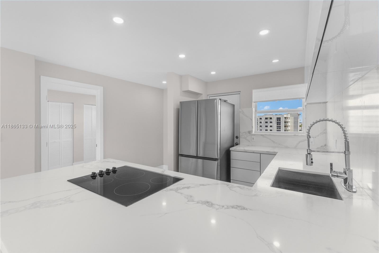 1331 Lincoln Road, Unit 1302 Miami Beach, FL 33139 - Photo 28 of 40 a large bedroom with a bed and a large window