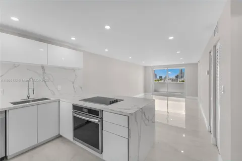 a kitchen that has a sink and a stove in it