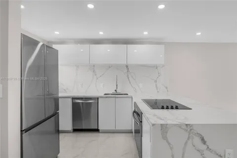 a kitchen with kitchen island a counter top space and stainless steel appliances