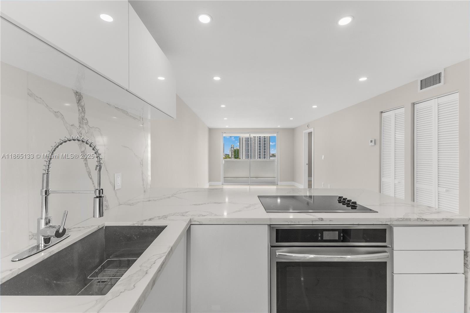 1331 Lincoln Road, Unit 1302 Miami Beach, FL 33139 - Photo 6 of 40 a kitchen with a sink stove and cabinets