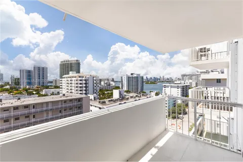 a open kitchen with kitchen island a stove and a refrigerator