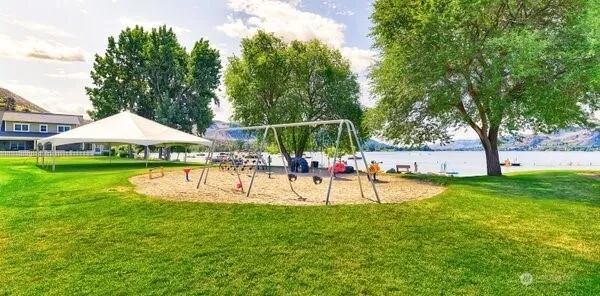 a view of a swimming pool with lawn chairs and plants