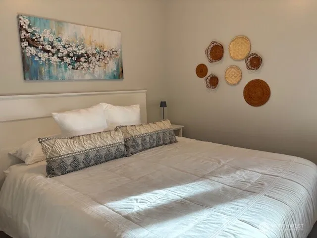 a bedroom with a bed and cabinets