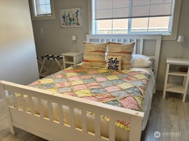 a bed sitting in a bedroom next to a window