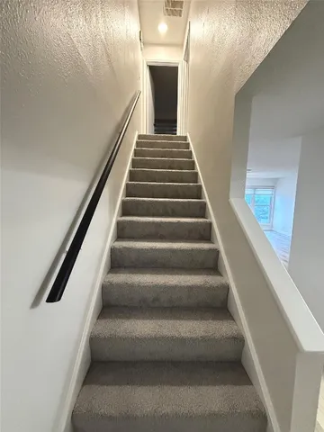 a view of empty room with wooden floor and fireplace