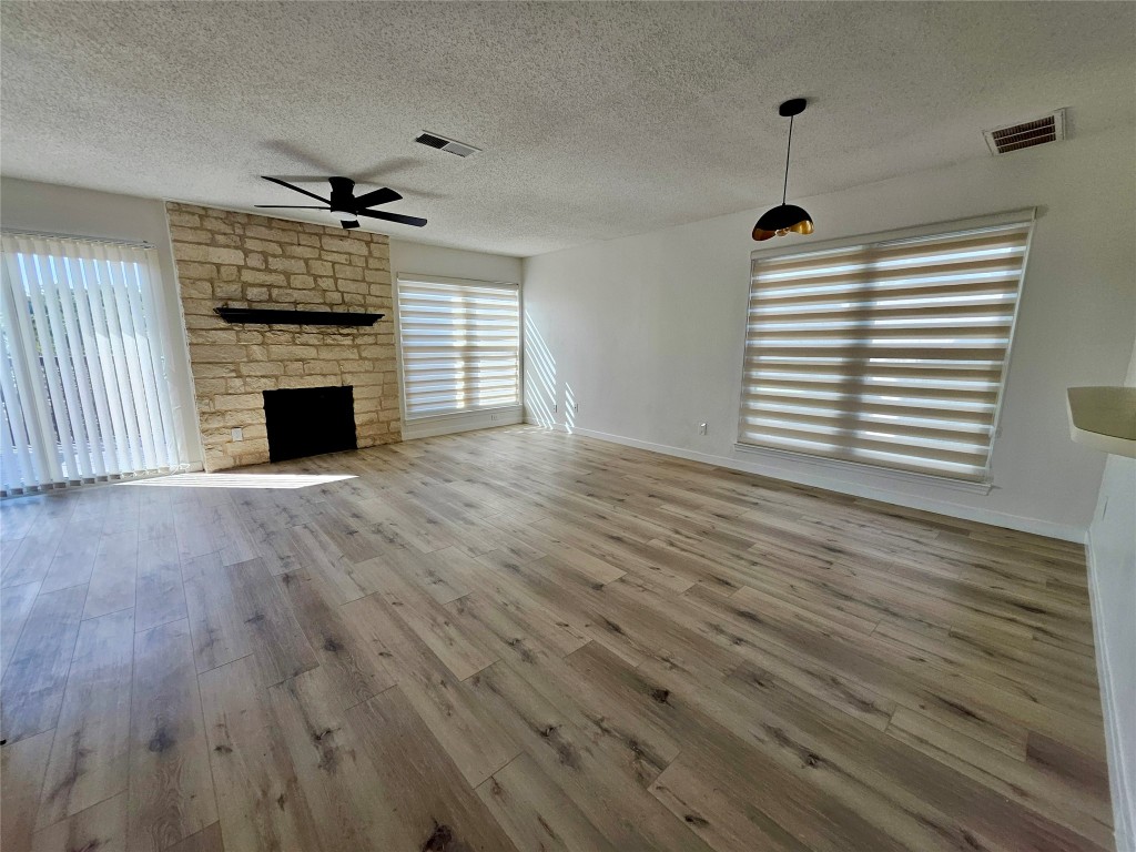 6806 Old Quarry Lane Austin, TX 78731 - Photo 15 of 29 a view of empty room with wooden floor and fireplace