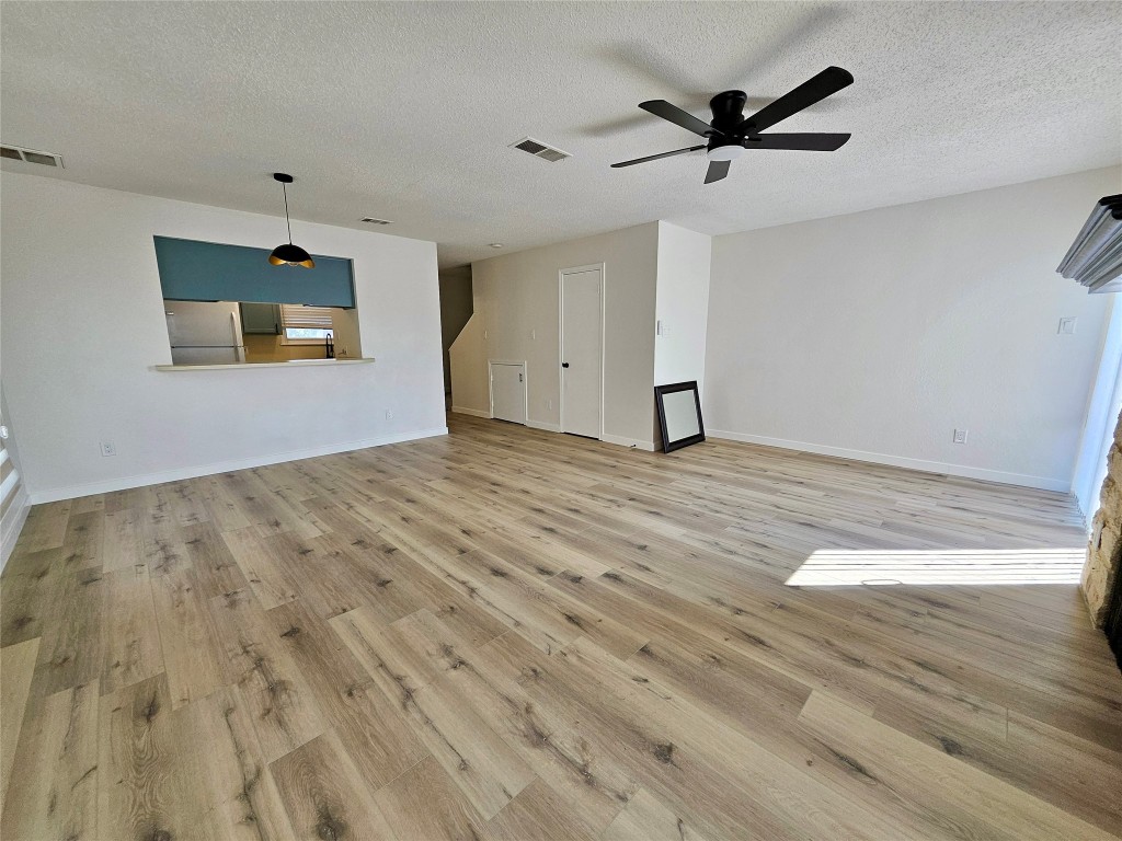 6806 Old Quarry Lane Austin, TX 78731 - Photo 16 of 29 a view of empty room with wooden floor and ceiling fan
