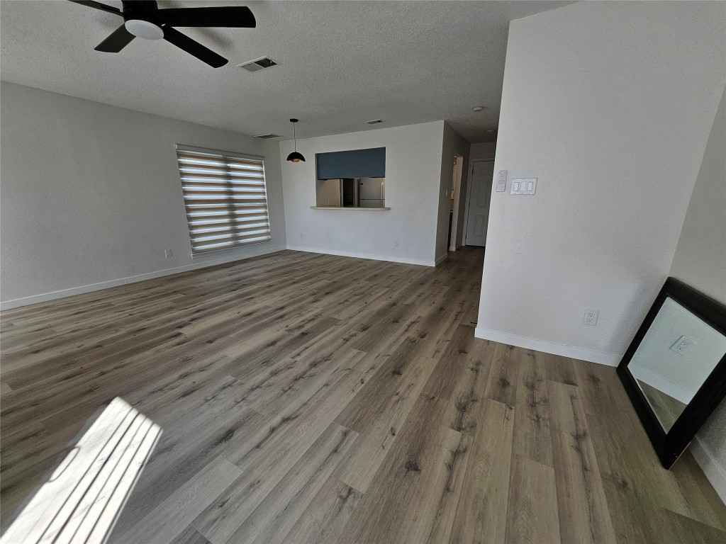 6806 Old Quarry Lane Austin, TX 78731 - Photo 18 of 29 wooden floor in an empty room with a window