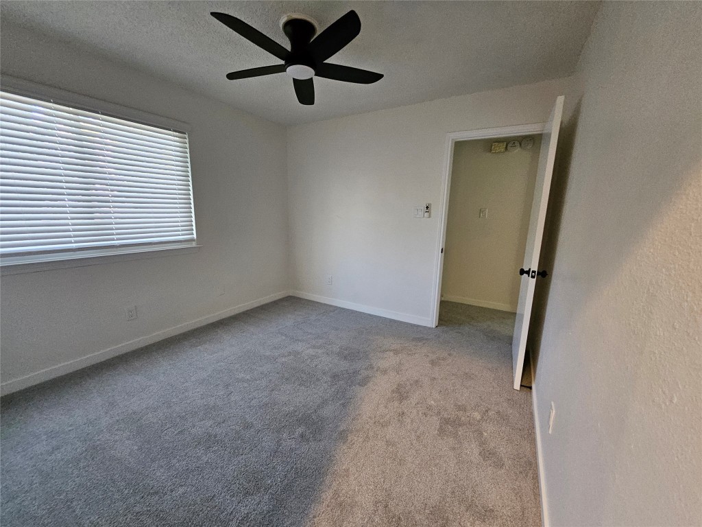 6806 Old Quarry Lane Austin, TX 78731 - Photo 23 of 29 an empty room with a window and a fan
