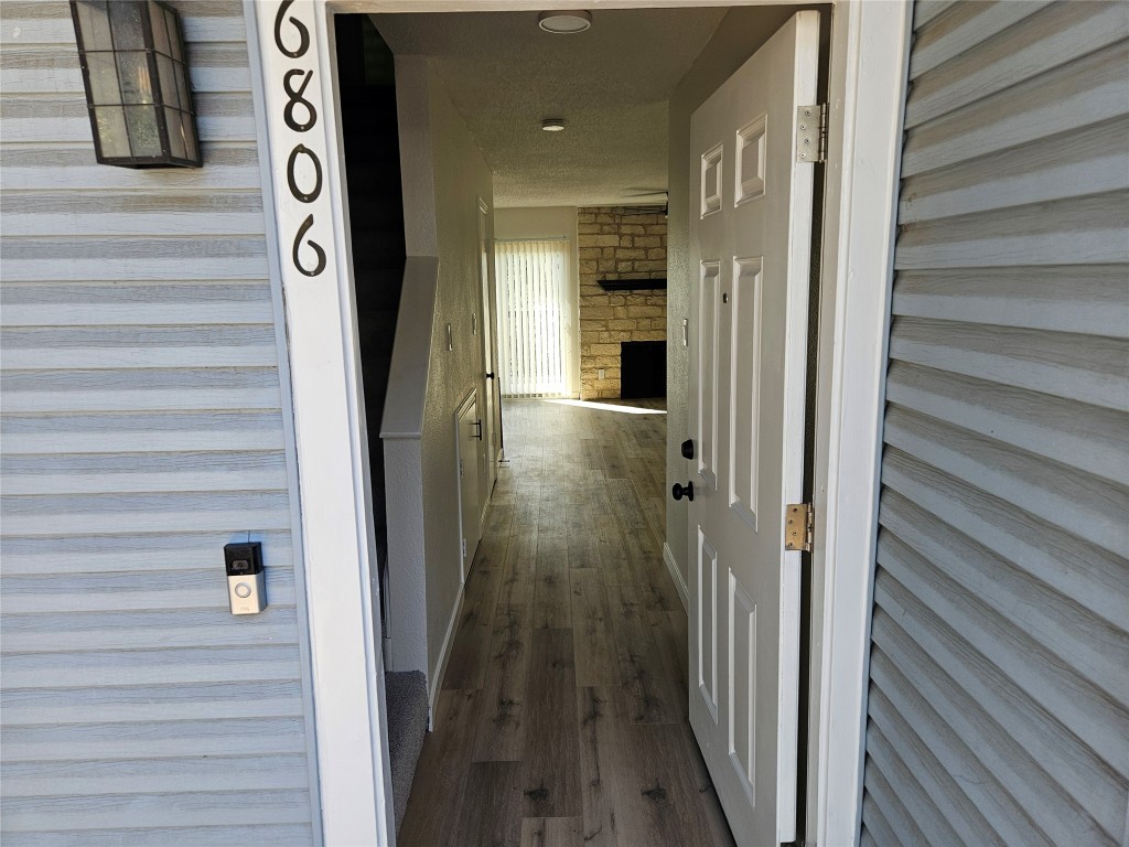6806 Old Quarry Lane Austin, TX 78731 - Photo 5 of 29 a view of a hallway with wooden floor and staircase