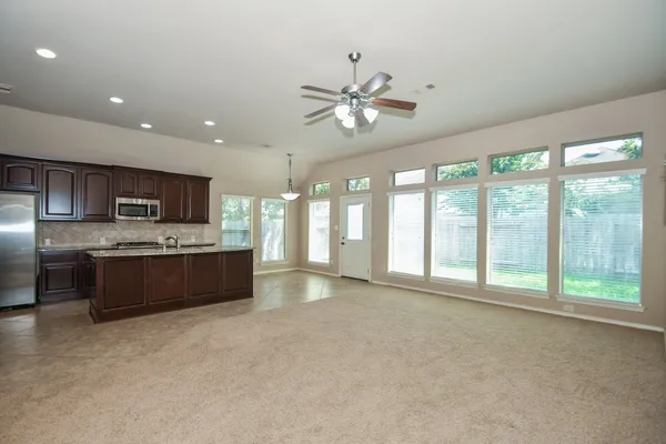 a large white kitchen with a large window
