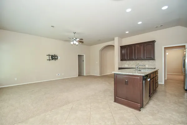 a kitchen with granite countertop a stove and a sink