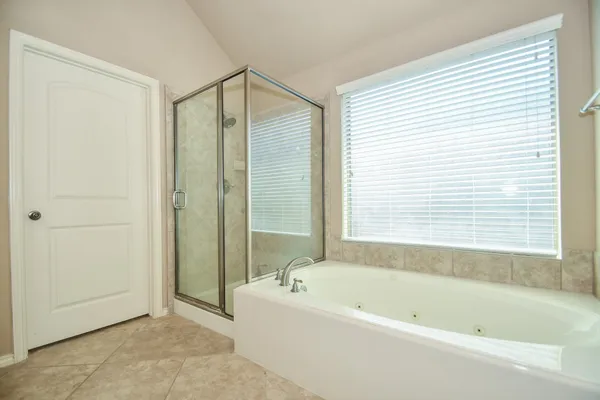 a bathroom with a bathtub and a shower