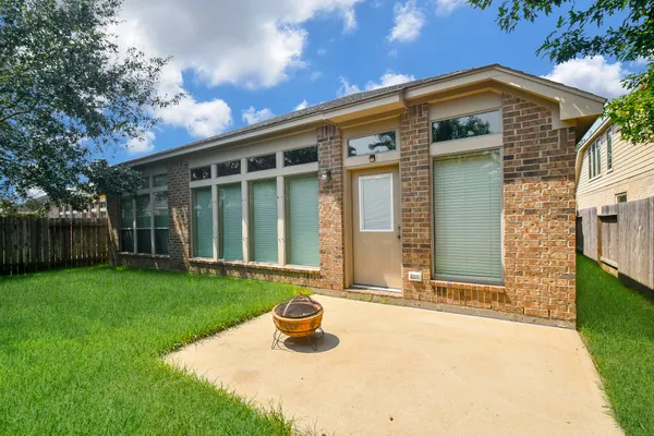 a front view of a house with yard and green space