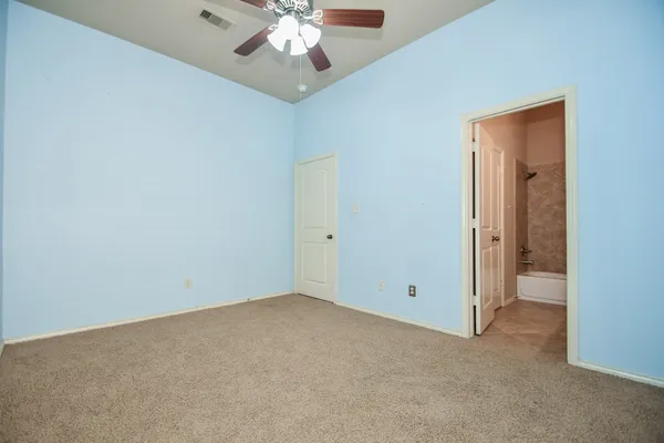 a bathroom with a granite countertop sink toilet mirror and bathtub