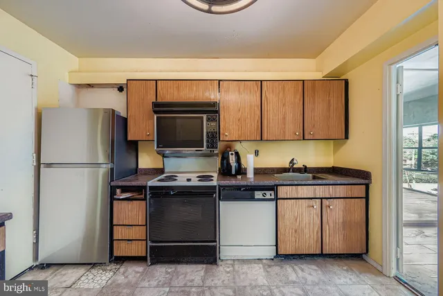 a kitchen with a sink appliances and cabinets