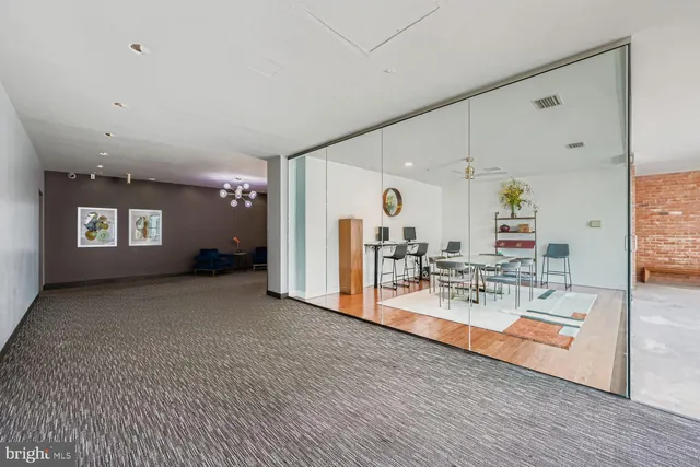 a view of a living room and kitchen with a table chairs