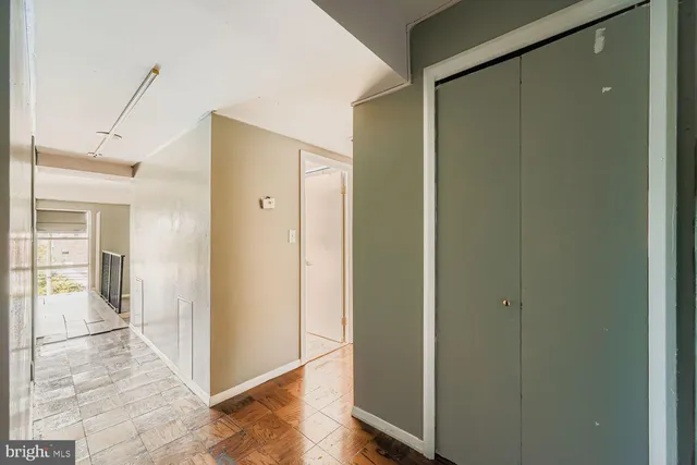 a view of a hallway with wooden floor