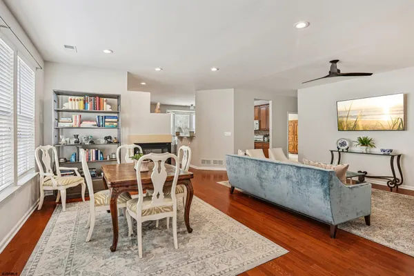 a kitchen with stainless steel appliances granite countertop a stove and a wooden floors
