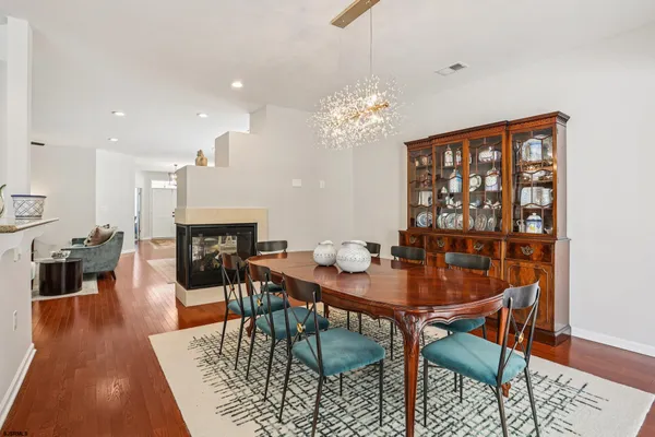 a living room with furniture a wooden floor and a bookshelf