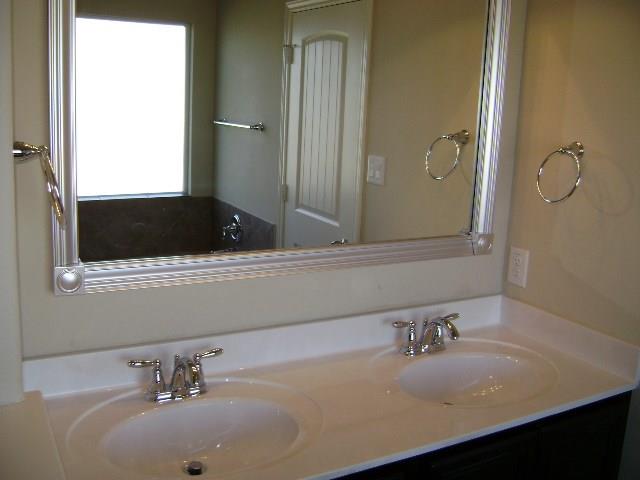 8513 Inca Dove Drive, Unit 363 Austin, TX 78729 - Photo 11 of 15 a bathroom with a sink and a mirror