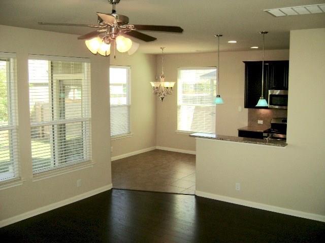 8513 Inca Dove Drive, Unit 363 Austin, TX 78729 - Photo 3 of 15 a view of empty room with wooden floor and fan