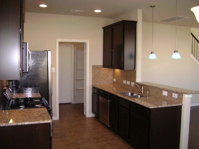 8513 Inca Dove Drive, Unit 363 Austin, TX 78729 - Photo 6 of 15 a bathroom with a sink and a mirror