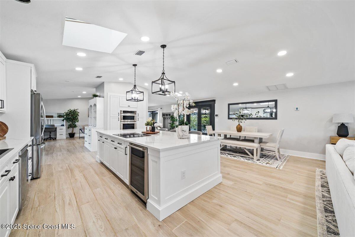 470 Rio Vista Lane Merritt Island, FL 32952 - Photo 12 of 54 a large kitchen with stainless steel appliances a lot of counter space and wooden floor