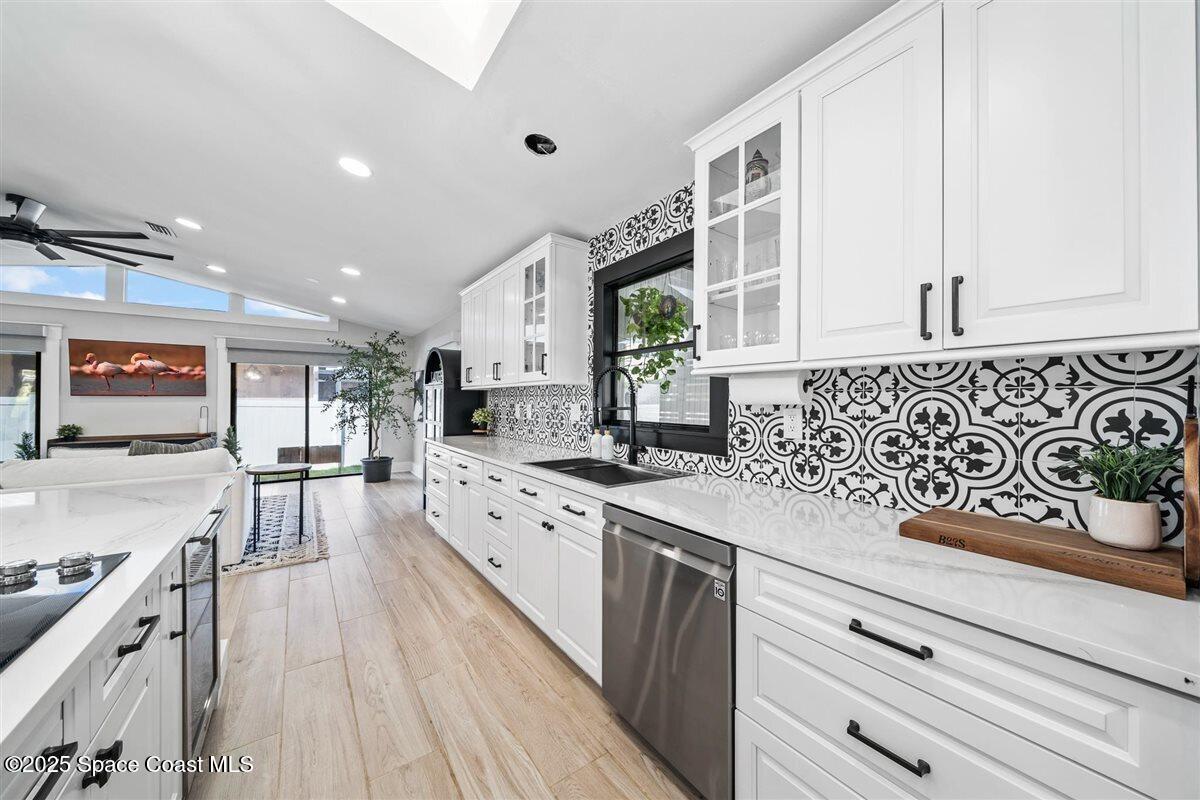 470 Rio Vista Lane Merritt Island, FL 32952 - Photo 13 of 54 a kitchen with stainless steel appliances sink stove top oven and cabinets