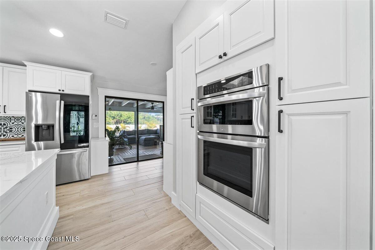 470 Rio Vista Lane Merritt Island, FL 32952 - Photo 14 of 54 a kitchen with stainless steel appliances a stove top oven and sink
