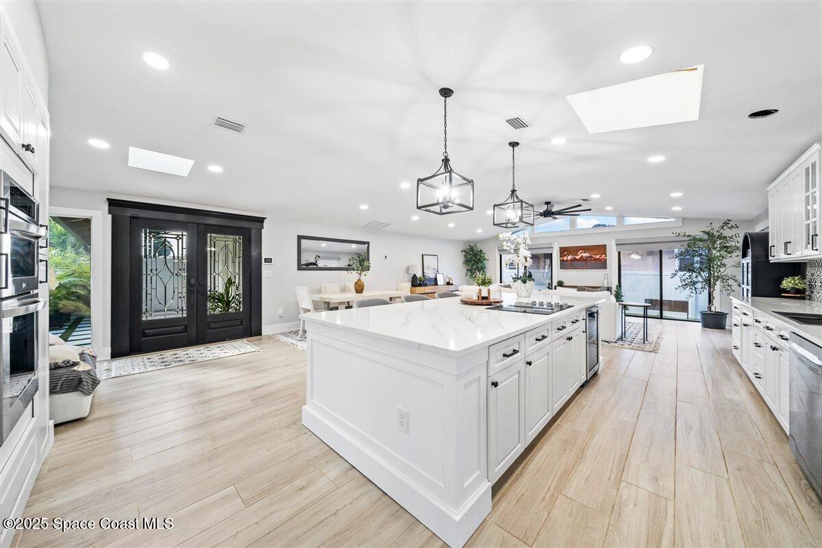 470 Rio Vista Lane Merritt Island, FL 32952 - Photo 15 of 54 a large white kitchen with a large center island and stainless steel appliances