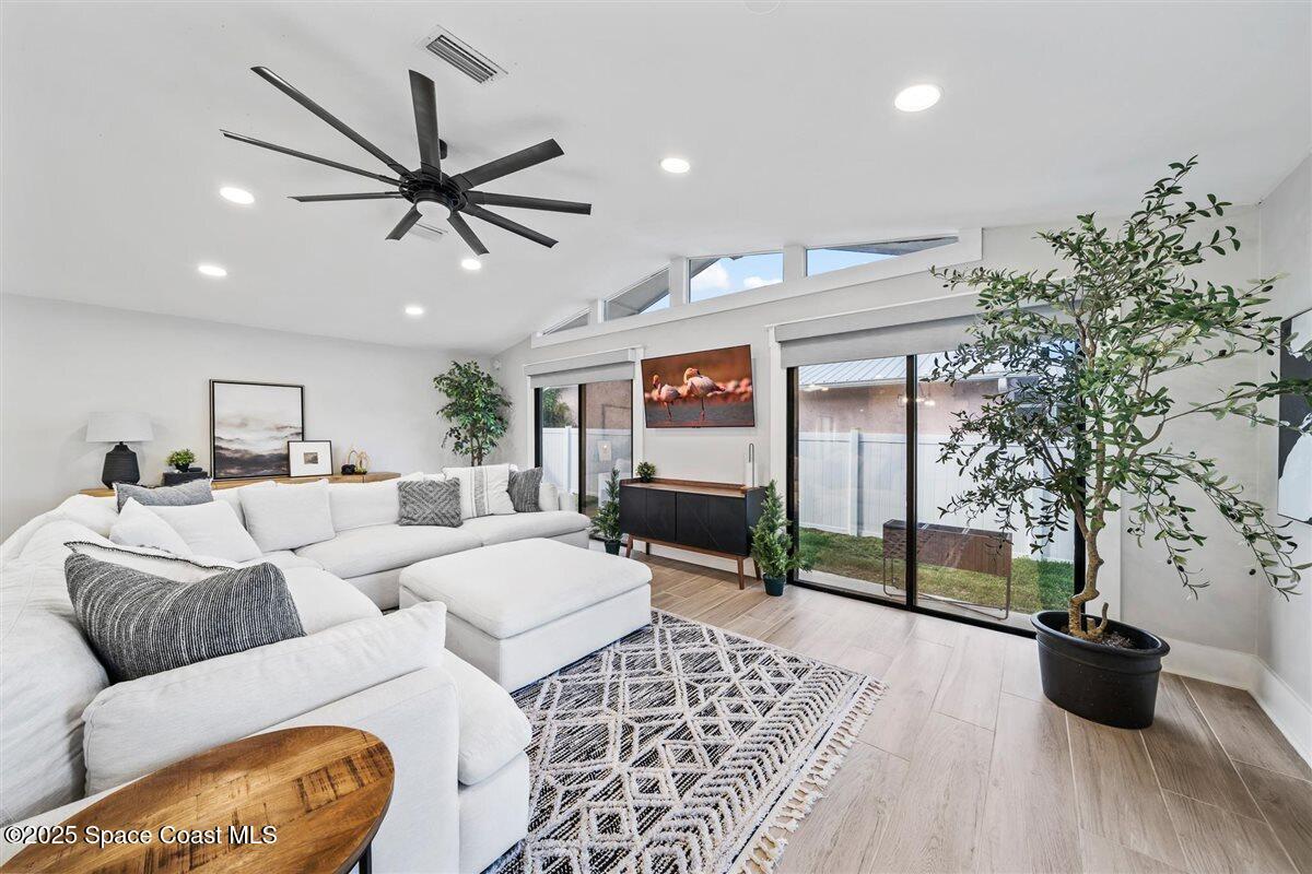 470 Rio Vista Lane Merritt Island, FL 32952 - Photo 16 of 54 a living room with furniture and a flat screen tv