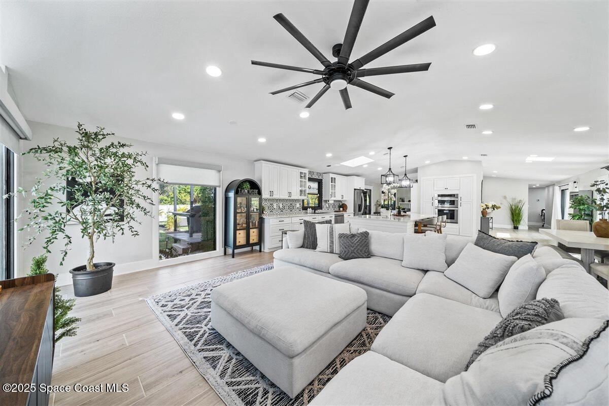470 Rio Vista Lane Merritt Island, FL 32952 - Photo 17 of 54 a living room with furniture and a large window