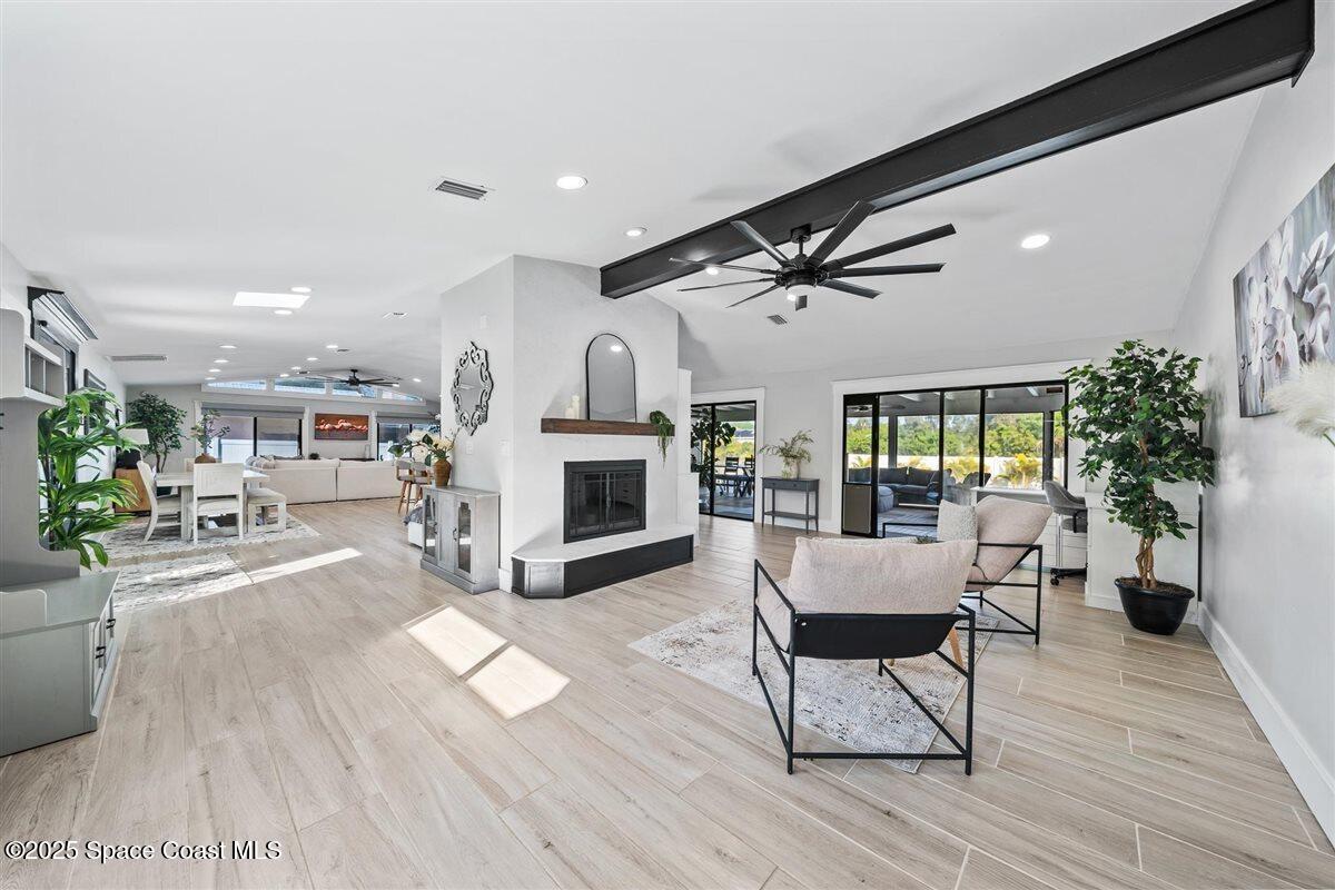 470 Rio Vista Lane Merritt Island, FL 32952 - Photo 20 of 54 a living room with furniture and a fireplace