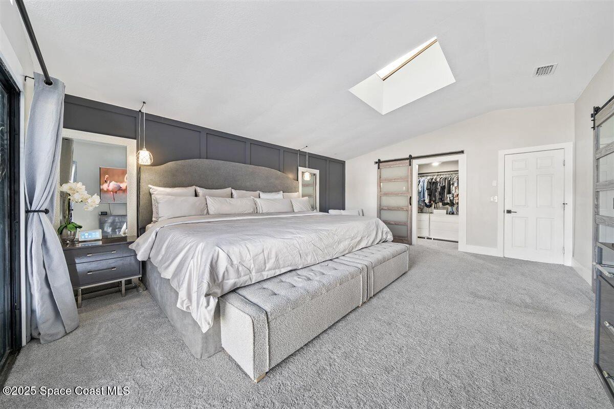 470 Rio Vista Lane Merritt Island, FL 32952 - Photo 23 of 54 a spacious bedroom with a bed and a lamp